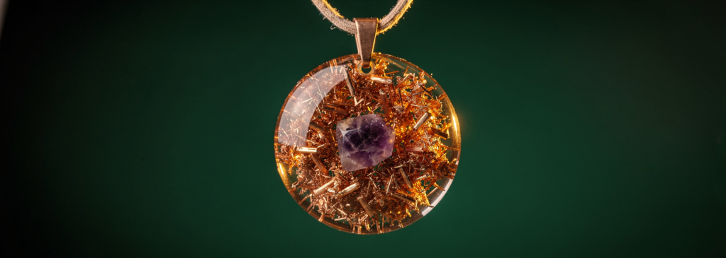 Orgone energy pendant with amethyst crystal and copper shavings in clear resin