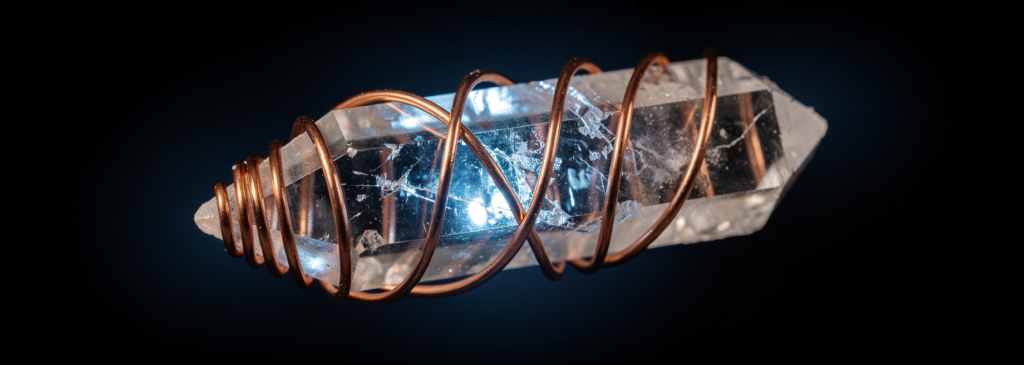 Double-terminated quartz crystal wrapped in copper mobius coil succor punch